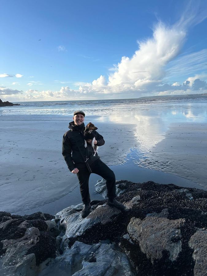 William Armstrong on the beach with his dog