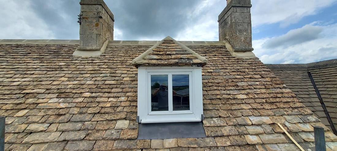 Cotswold stone roof with lime works on dormer window and chimneys