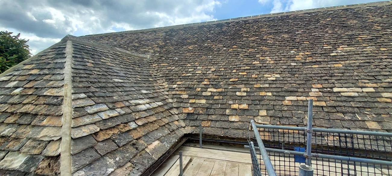 New Cotswold stone slate roof, hip and swept valley